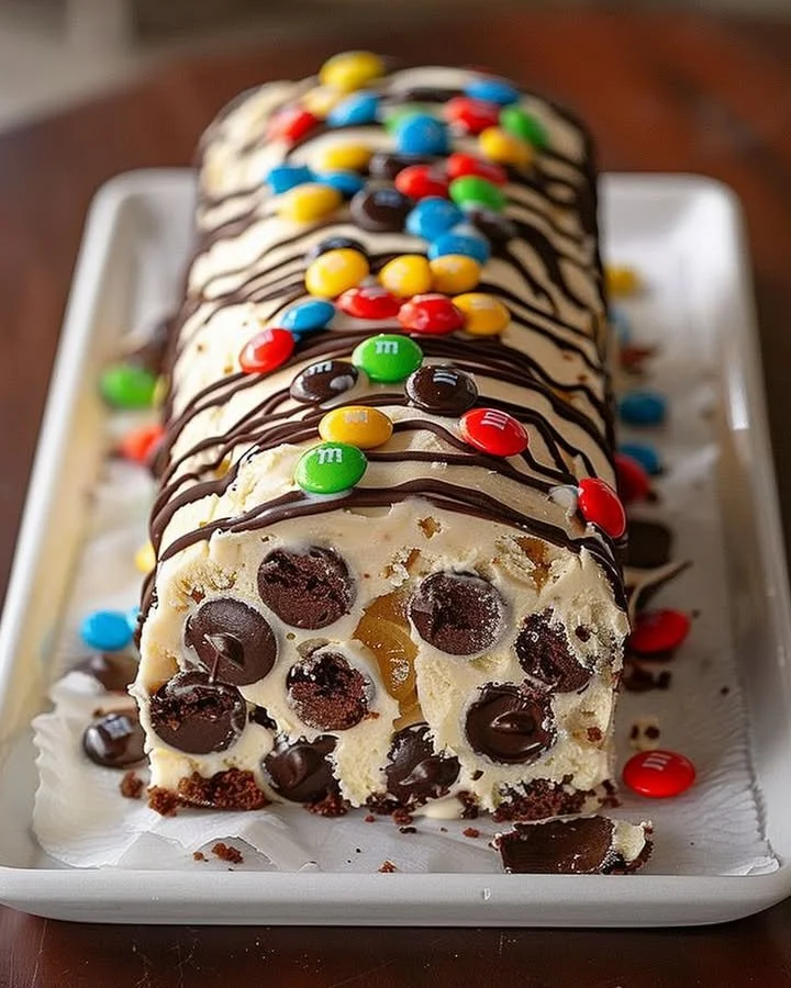 M&M's Chocolate Chip Cookie Dough Ice Cream Cake Roll plated and garnished.
