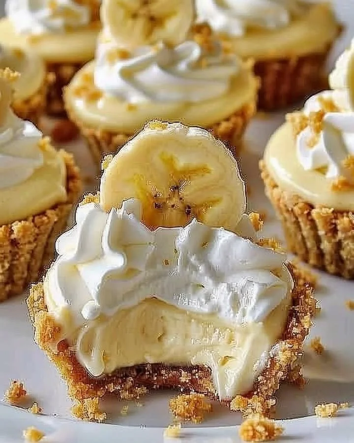 No-bake mini banana cream pies topped with whipped cream and banana slices.