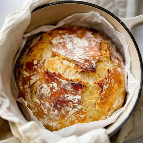 Freshly baked no knead artisan bread on a wooden table