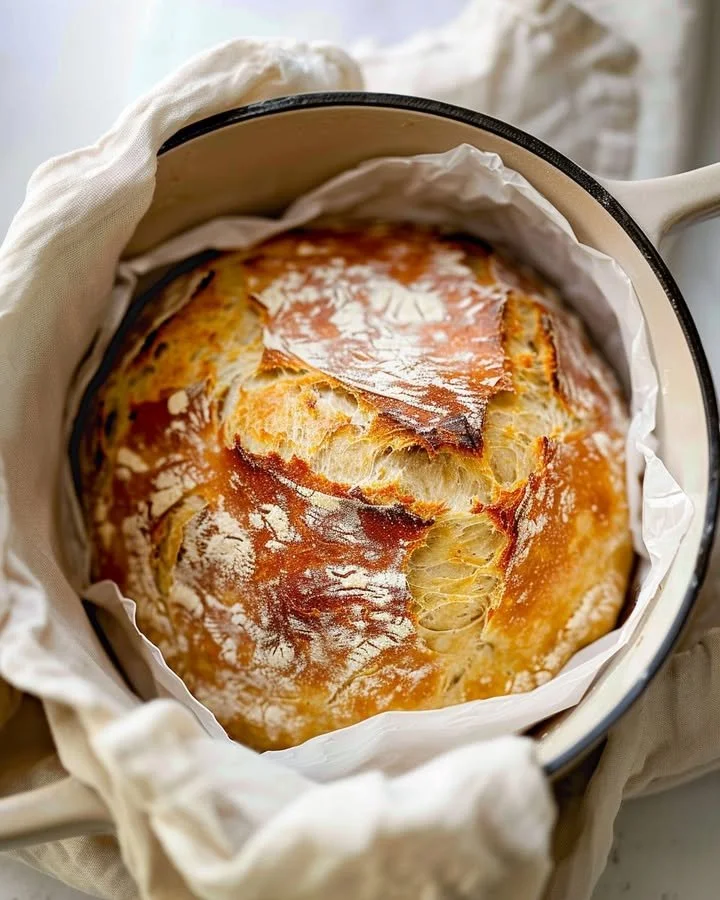 Freshly baked no knead artisan bread on a wooden table