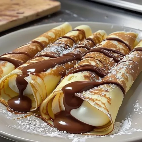 Nutella crepes filled with creamy Nutella and topped with chocolate drizzle