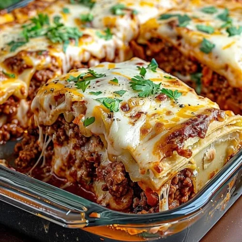 Pillsbury Crescent Roll Taco Bake topped with cheese and taco ingredients
