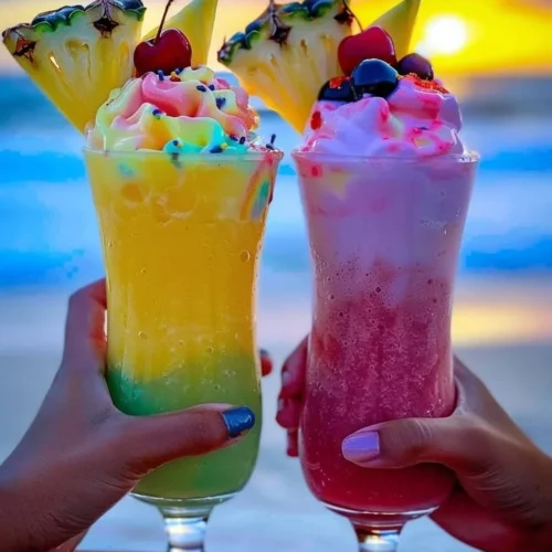 Colorful Rainbow Sherbet Piña Colada in a tropical setting