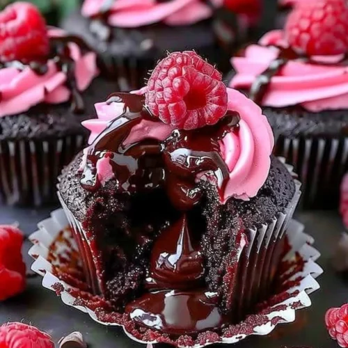 Decadent Raspberry Chocolate Lava Cupcakes with molten center and raspberry drizzle