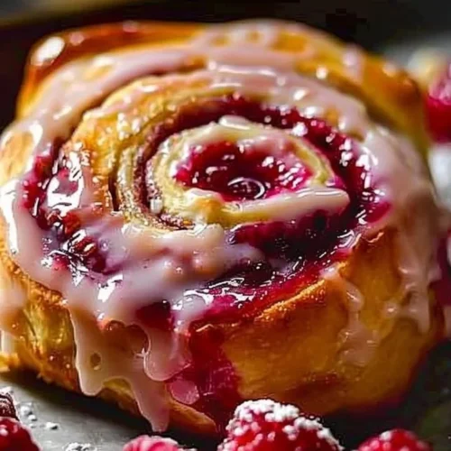 Freshly baked raspberry cinnamon rolls with icing on top