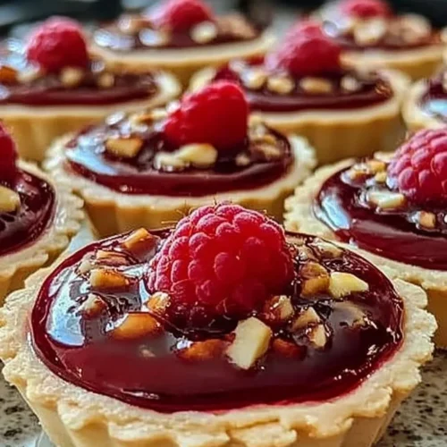 Delicious Raspberry Rhapsody Tarts with fresh raspberries and buttery crust