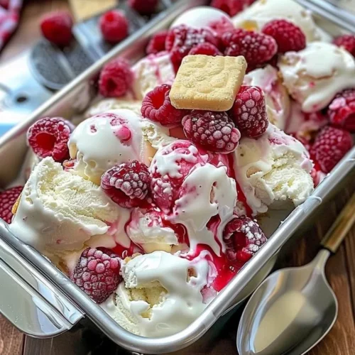 Delicious Raspberry Shortcake Ice Cream served in a bowl with fresh raspberries and whipped cream