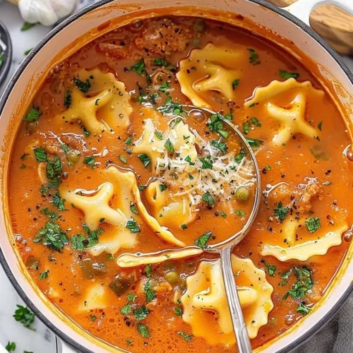 One Pot Ravioli Soup with fresh herbs and ingredients cooking in a pot