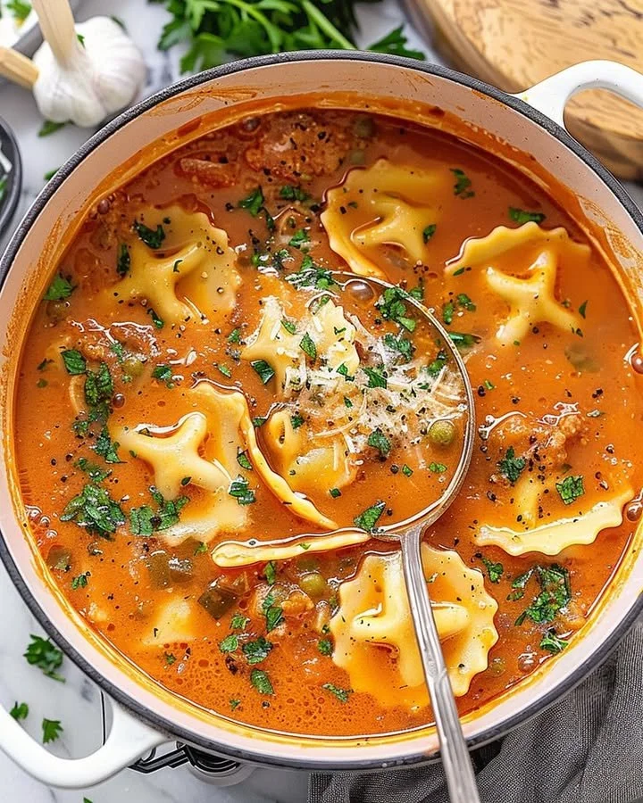 One Pot Ravioli Soup with fresh herbs and ingredients cooking in a pot