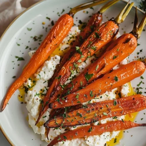 Plate of roasted carrots topped with whipped feta cheese