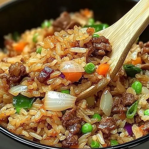 Savior Onion Beef Fried Rice served in a bowl with fresh herbs