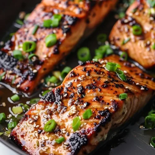 Silken miso-ginger glazed salmon served on a plate with vegetables