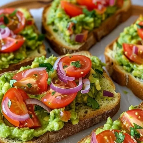 Delicious smashed avocado bruschetta topped with seasonings on toasted bread