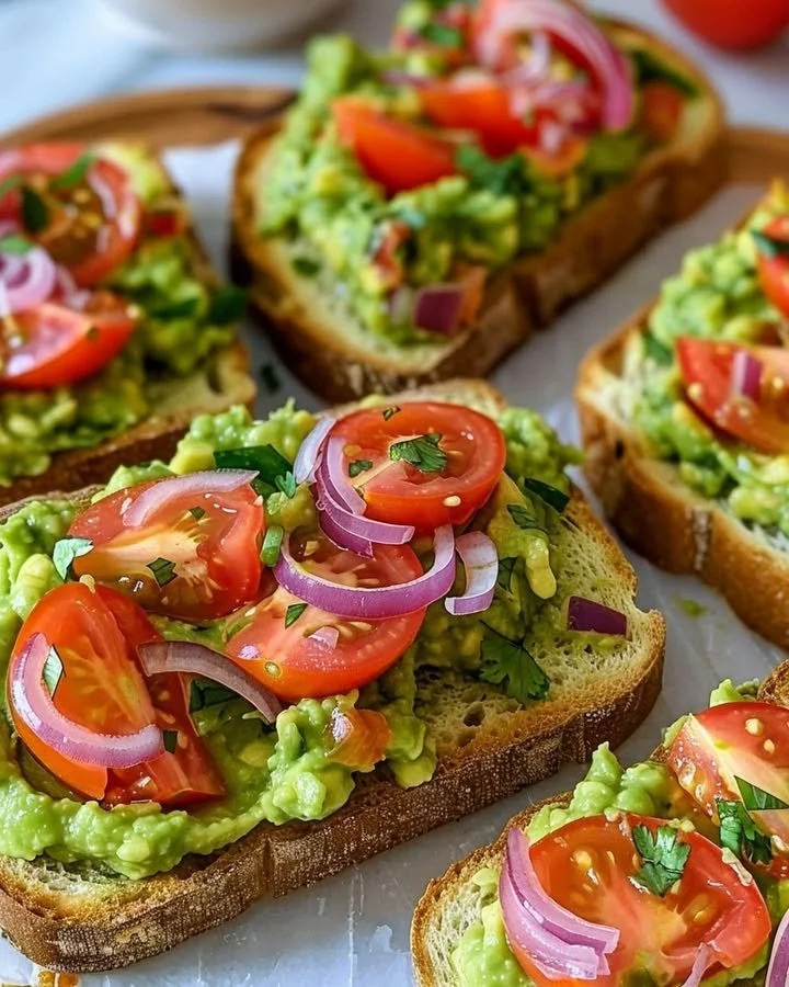 Delicious smashed avocado bruschetta topped with seasonings on toasted bread