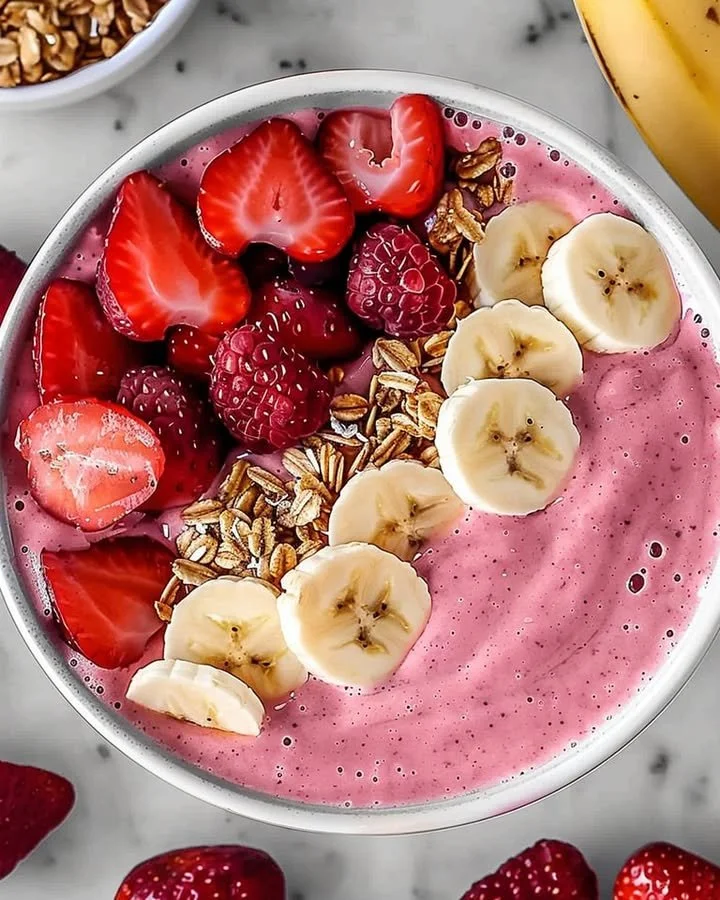 Delicious Strawberry Banana Smoothie in a glass topped with fresh fruit