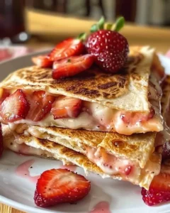 Delicious sweet strawberry cheesecake quesadillas on a plate