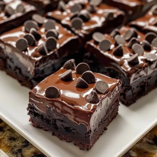Delicious triple chocolate fudge brownies topped with chocolate chunks