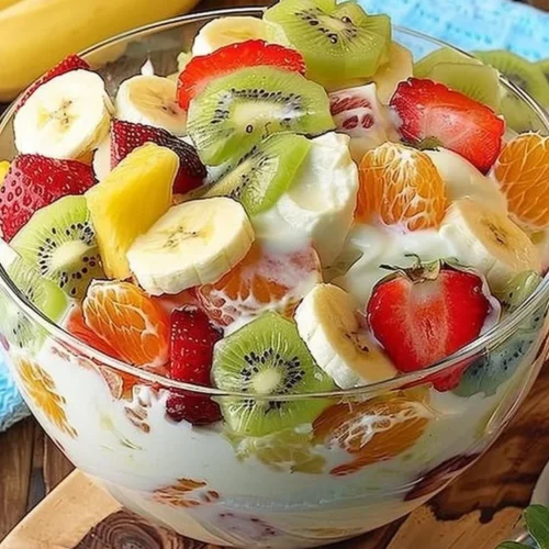 Tropical cheesecake fruit salad with mixed fruits on a plate.