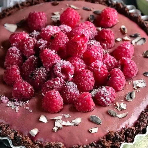 Delicious Vegan Raspberry Chocolate Tart with fresh raspberries and rich chocolate