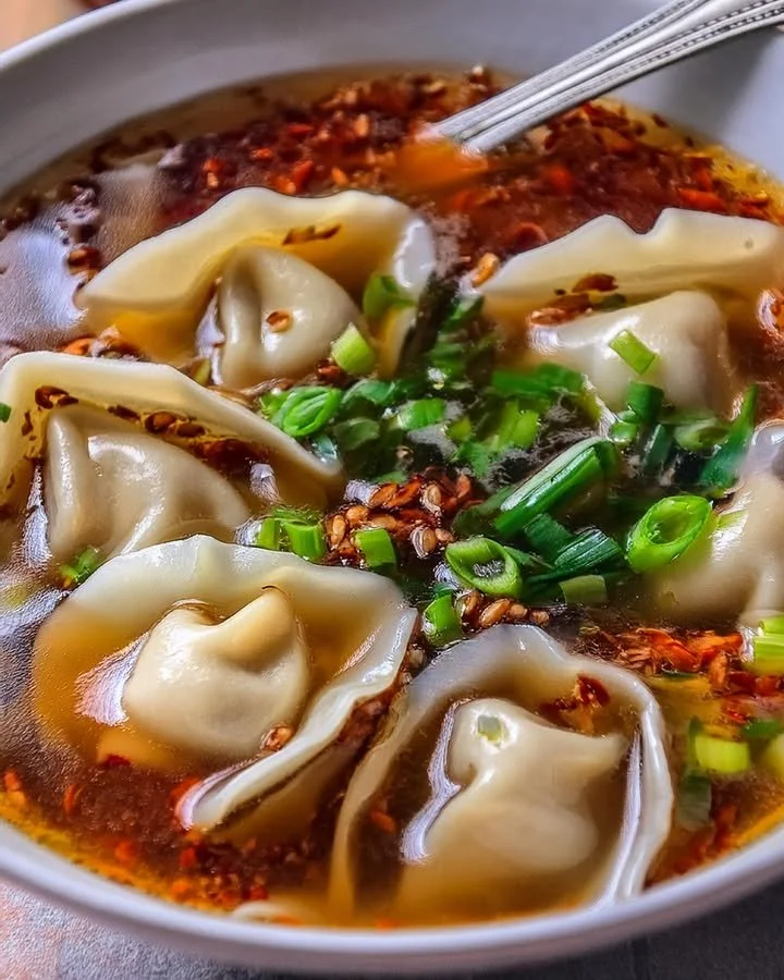 Bowl of homemade weeknight wonton soup with fresh vegetables and dumplings