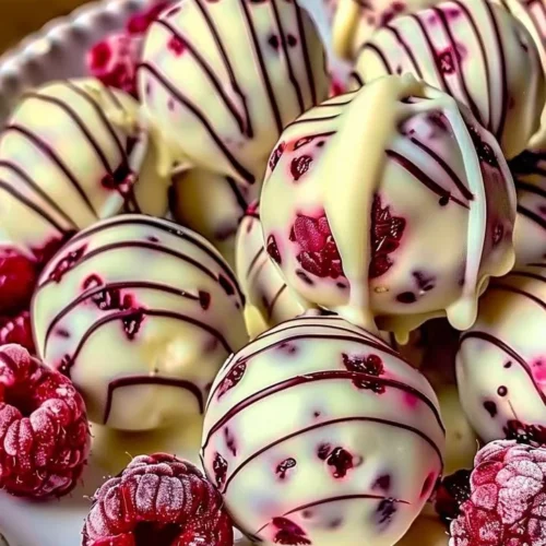 Delicious white chocolate raspberry cheesecake balls on a plate