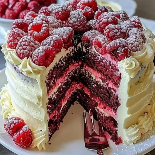 Delicious White Chocolate Raspberry Dream Cake with fresh raspberries and cream