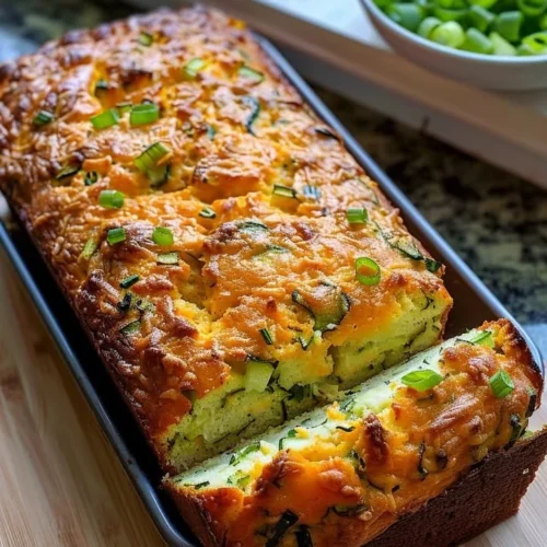 Slices of delicious homemade Zucchini Cheese Bread on a wooden cutting board